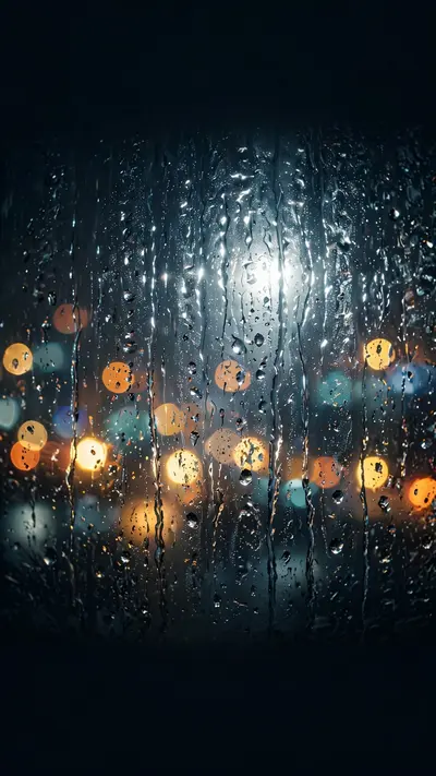 city lights blurred through a rain-streaked window, bokeh orbs, moody, vertical 9:16 phone wallpaper composition, subject centered in the upper