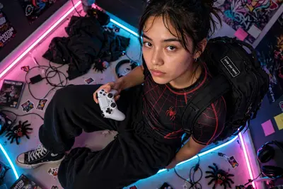 A candid, high-angle smartphone shot of a Gen Z women looking up with a deadpan expression. He is wearing a sleek black and red athletic compression