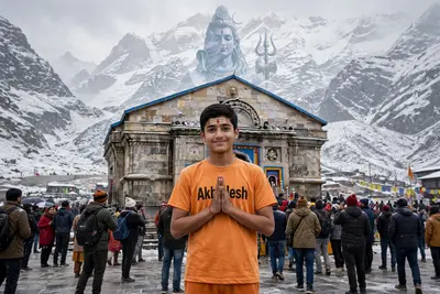 18 year old indian boy is standing with folded two hand with at the Kedarnath temple. The lord shiva image in low opacity on mountain. A boy wearing