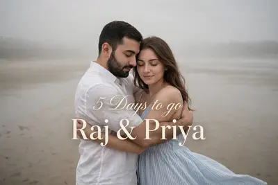A soft, romantic pre wedding photograph of a young couple embracing on a vast, sandy beach. The man, with a short, dark beard, wears a crisp white